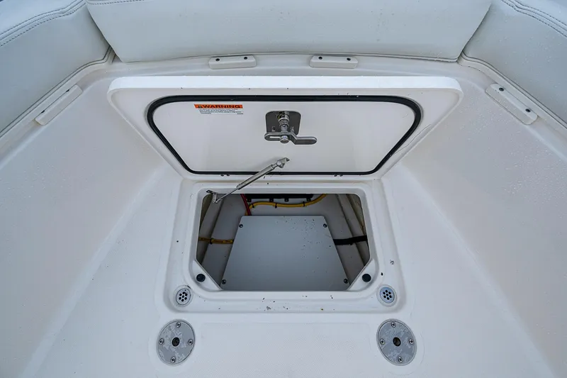 Pigasus Yacht Photos Pics 2024 Pursuit S 328 Sport boat storage compartment with open hatch and secure latch.