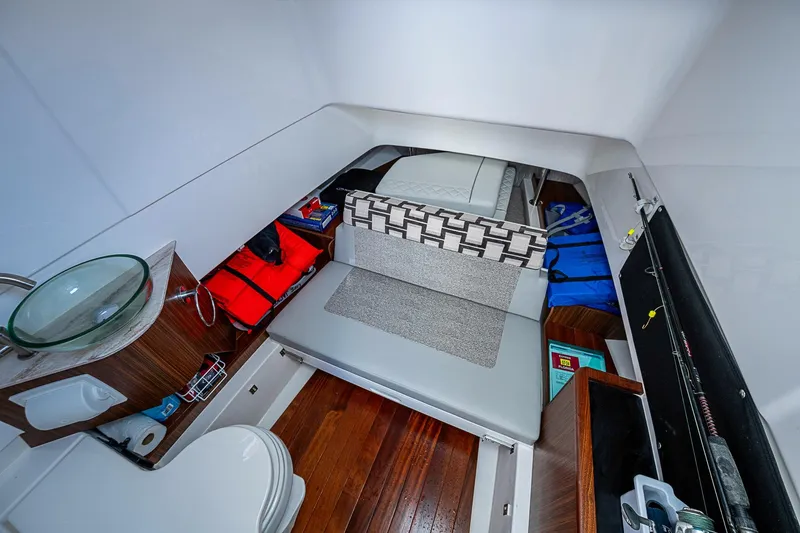 Pigasus Yacht Photos Pics 2024 Pursuit S 328 Sport cabin interior with seating, sink, and storage.