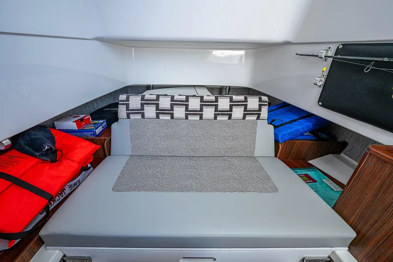 Pigasus Yacht Photos Pics 2024 Pursuit S 328 Sport cabin interior with seating and storage compartments.