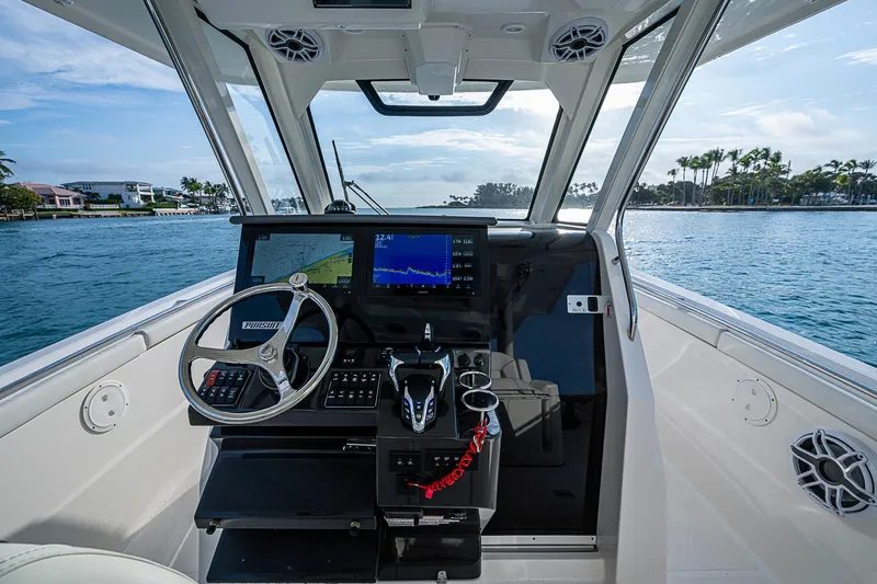 Pigasus Yacht Photos Pics 2024 Pursuit S 328 Sport boat helm with modern controls and ocean view.