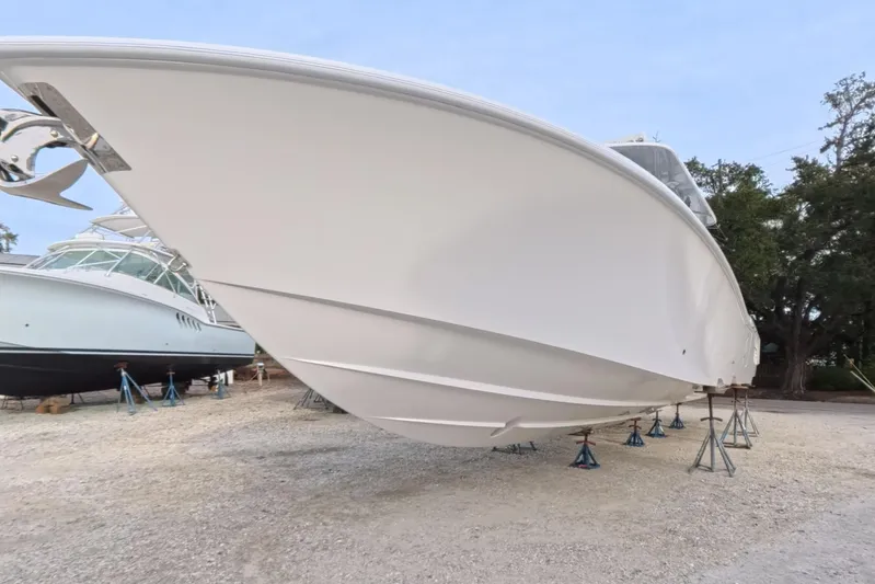 Foolish Pleasure Yacht Photos Pics 2025 Invincible 39 Open Fisherman boat on stands, side view.