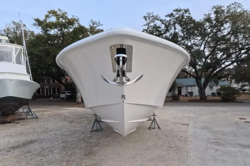 Foolish Pleasure Yacht Photos Pics 2025 Invincible 39 Open Fisherman boat on display, front view with trees in background.