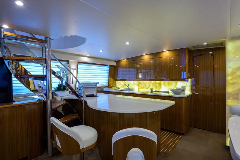  Yacht Photos Pics Luxurious interior of a 2007 Viking Enclosed Bridge yacht with modern kitchen and seating area.