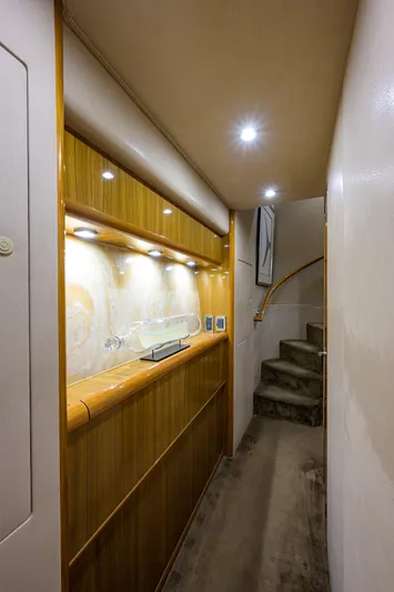  Yacht Photos Pics Interior of 2007 Viking Enclosed Bridge yacht with wooden cabinetry and carpeted stairs.