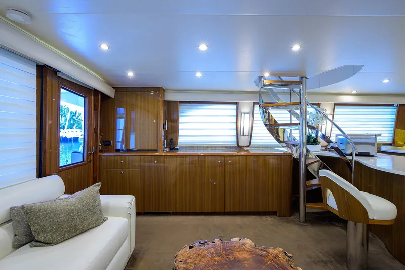  Yacht Photos Pics Luxurious interior of 2007 Viking Enclosed Bridge yacht with modern furnishings and elegant wood finishes.