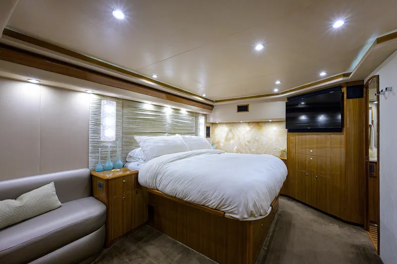  Yacht Photos Pics Luxurious 2007 Viking Enclosed Bridge yacht bedroom with modern lighting and elegant wood finishes.