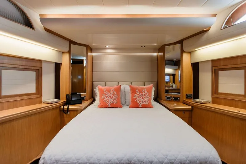 3w Yacht Photos Pics Luxurious bedroom interior of 2010 Horizon 74 Motoryacht with elegant wood finish and coral accents.