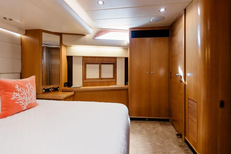 3w Yacht Photos Pics Luxurious cabin interior of 2010 Horizon 74 Motoryacht with wood finish and coral pillow.
