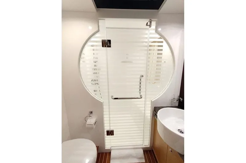 3w Yacht Photos Pics Luxurious bathroom on 2010 Horizon 74 Motoryacht with modern glass shower and sleek fixtures.