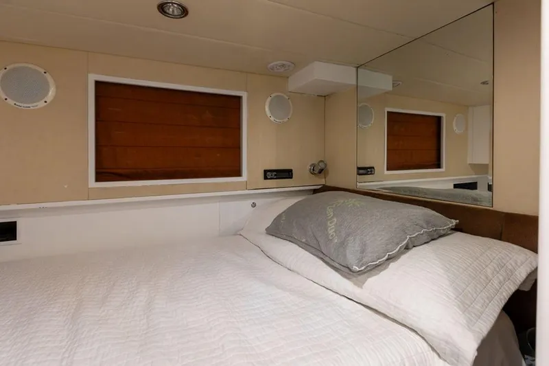 3w Yacht Photos Pics Cozy bedroom interior of 2010 Horizon 74 Motoryacht with mirror and wooden accents.