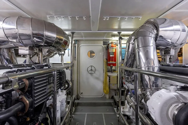 3w Yacht Photos Pics Engine room of 2010 Horizon 74 Motoryacht with polished metal components and safety equipment.