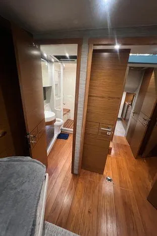  Yacht Photos Pics Interior of 2020 Tiara Yachts 53 Coupe, featuring wood flooring and modern bathroom.
