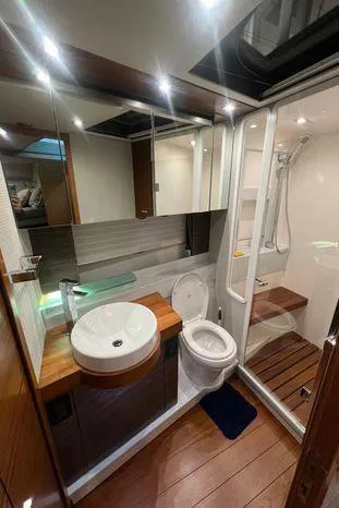 Yacht Photos Pics Luxury bathroom in 2020 Tiara Yachts 53 Coupe with modern fixtures and wooden accents.
