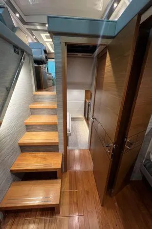  Yacht Photos Pics Interior of 2020 Tiara Yachts 53 Coupe, featuring wooden stairs and modern design.