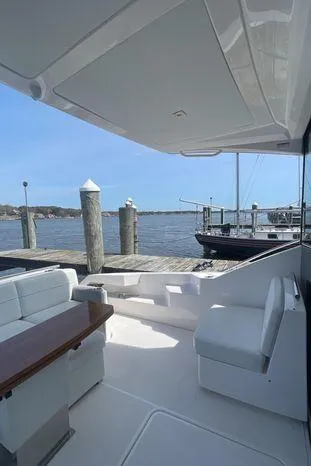  Yacht Photos Pics 2020 Tiara Yachts 53 Coupe docked, featuring sleek seating and waterfront view.