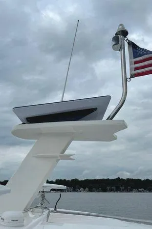  Yacht Photos Pics 2020 Tiara Yachts 53 Coupe with American flag, cloudy sky background.