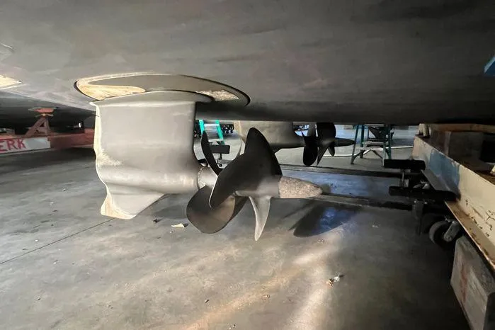  Yacht Photos Pics Propeller and rudder of a 2020 Tiara Yachts 53 Coupe in a workshop.
