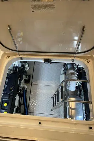  Yacht Photos Pics Engine compartment of 2020 Tiara Yachts 53 Coupe, showcasing mechanical components and ladder.