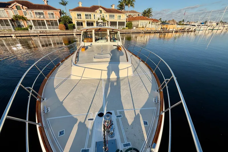 Last Dance Yacht Photos Pics 2001 Grand Banks 49 Eastbay HX yacht docked near waterfront homes.