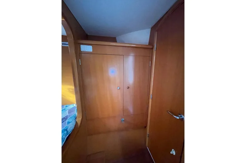 Yolo Yacht Photos Pics Interior of 2006 Lagoon 410-S2 yacht with wooden cabinetry and door.