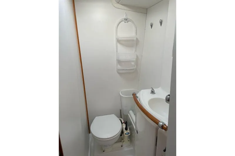 Yolo Yacht Photos Pics Compact bathroom in 2006 Lagoon 410-S2 yacht with toilet and sink.