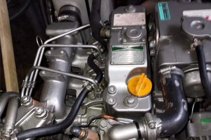 Yolo Yacht Photos Pics Engine compartment of a 2006 Lagoon 410-S2 catamaran, showing mechanical components and hoses.