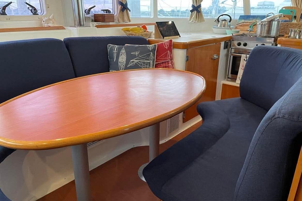 Interior of 2006 Lagoon 410-S2 yacht with dining area and kitchen.