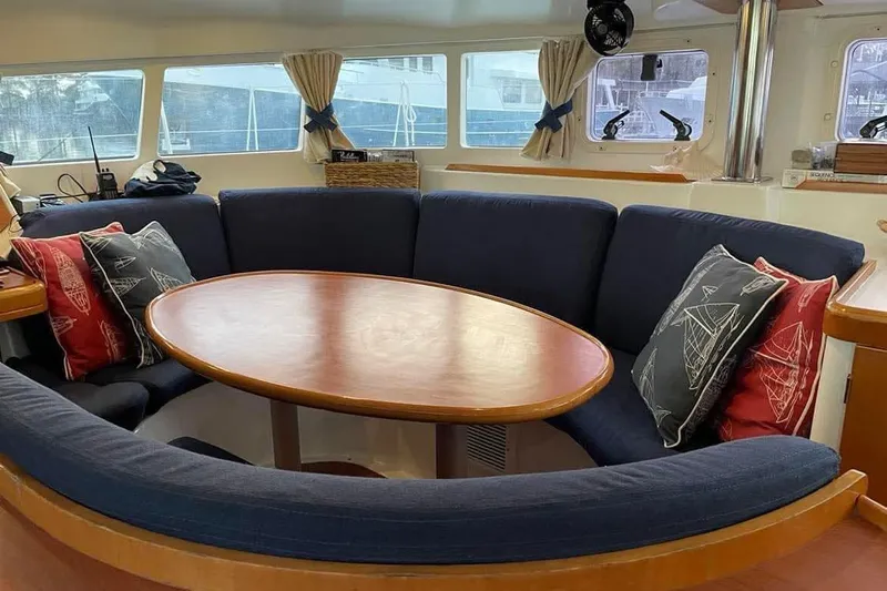 Yolo Yacht Photos Pics Interior of 2006 Lagoon 410-S2 yacht with cozy seating and nautical-themed cushions.