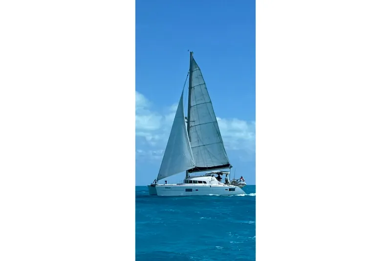Yolo Yacht Photos Pics 2006 Lagoon 410-S2 catamaran sailing on clear blue ocean waters.