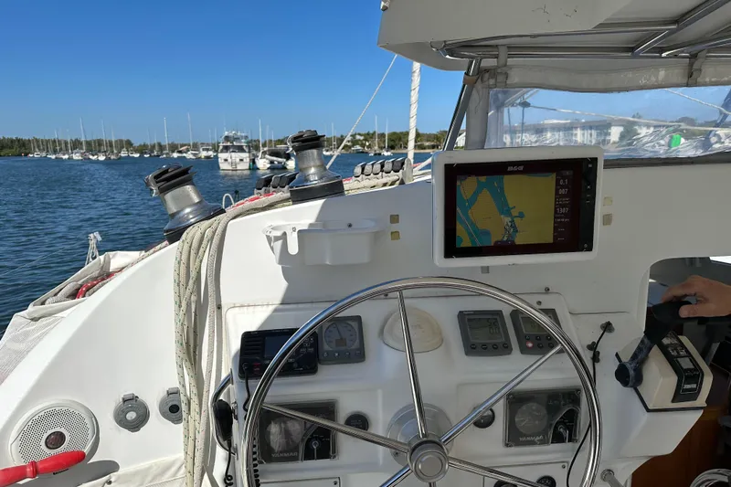 Yolo Yacht Photos Pics Steering area of a 2006 Lagoon 410-S2 catamaran with navigation equipment and marina view.
