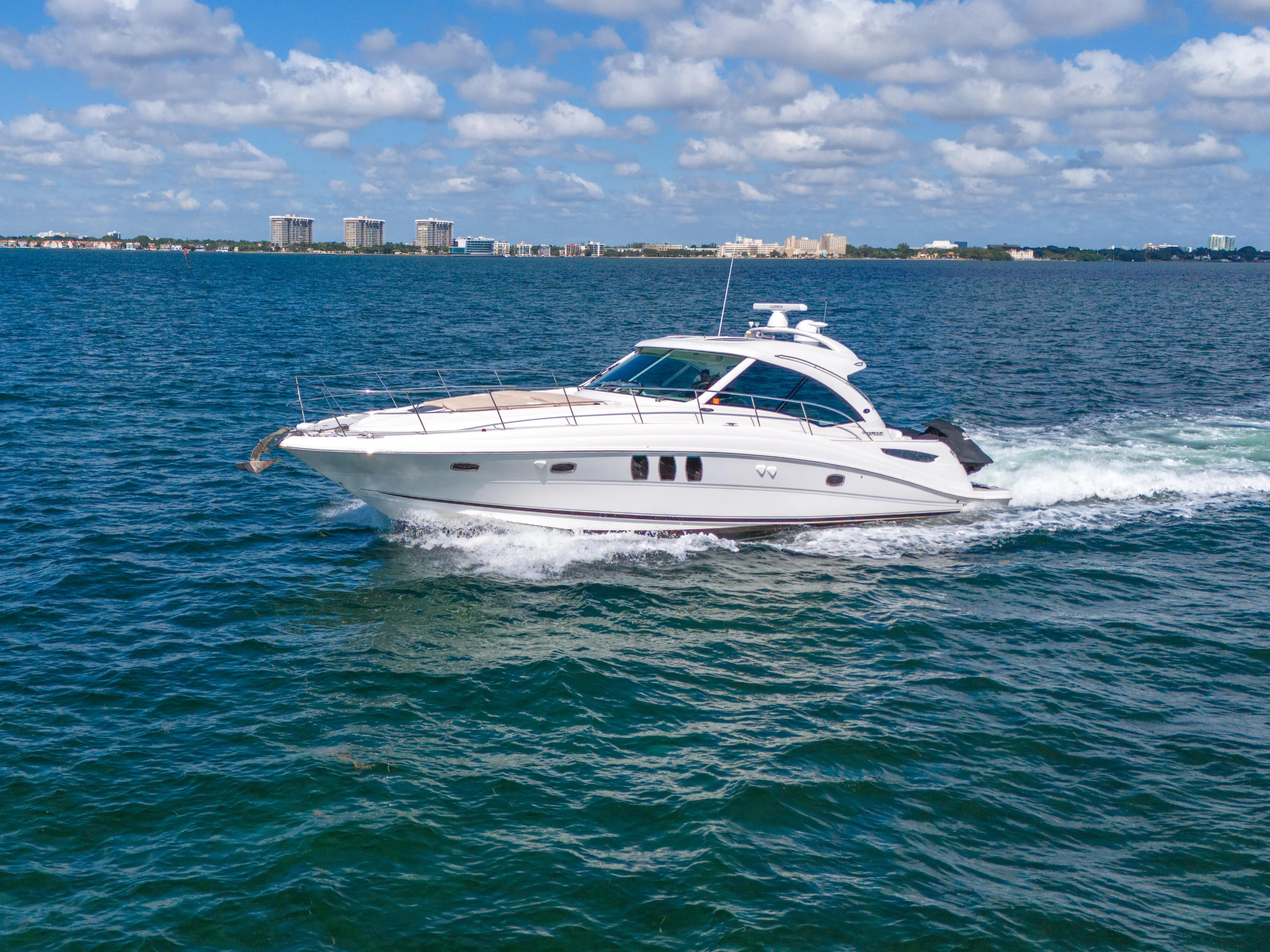  Yacht Photos Pics 2010 Sea Ray 500 Sundancer cruising on open water under a partly cloudy sky.