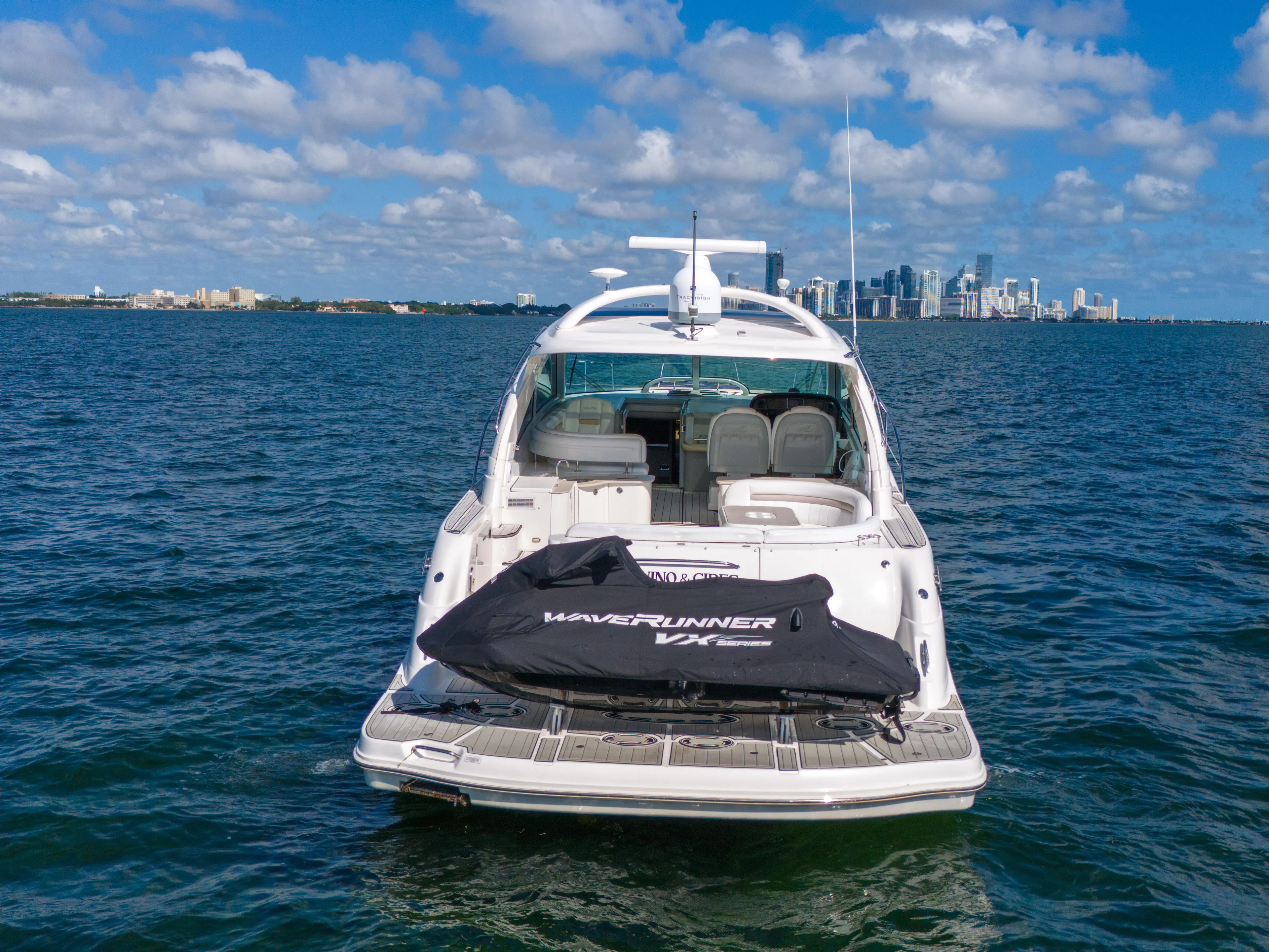  Yacht Photos Pics 2010 Sea Ray 500 Sundancer yacht on open water with city skyline in background.