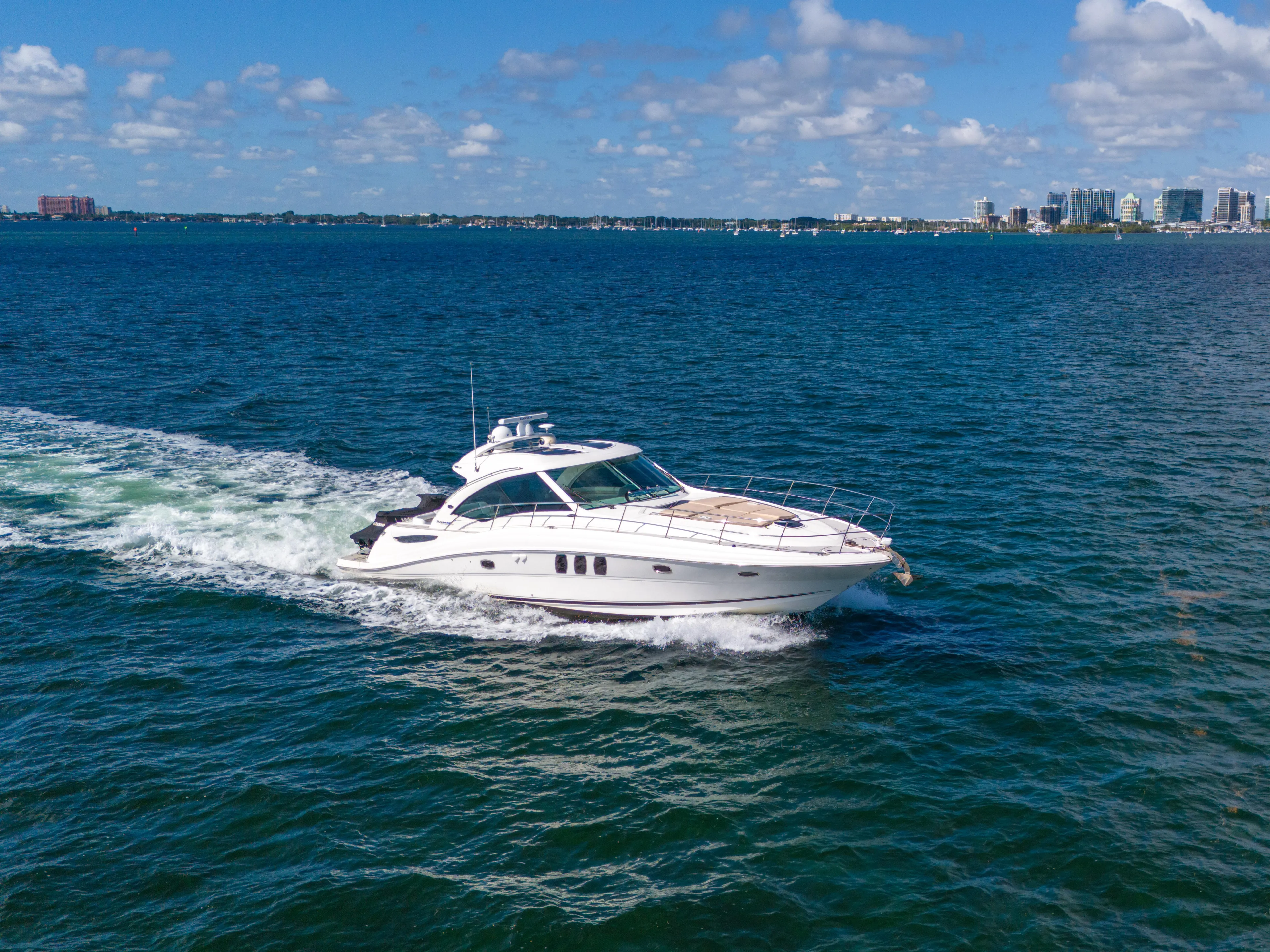  Yacht Photos Pics 2010 Sea Ray 500 Sundancer cruising on open water under a clear blue sky.