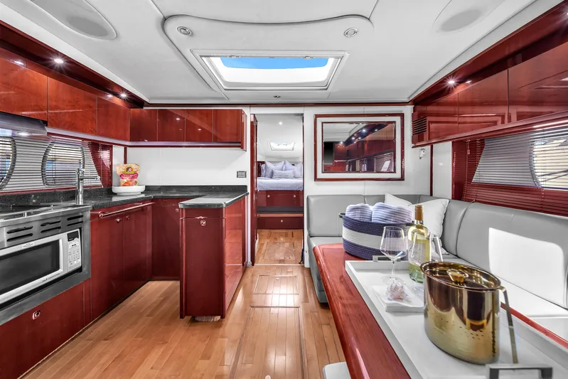  Yacht Photos Pics Luxurious interior of 2010 Sea Ray 500 Sundancer yacht with modern kitchen and seating area.