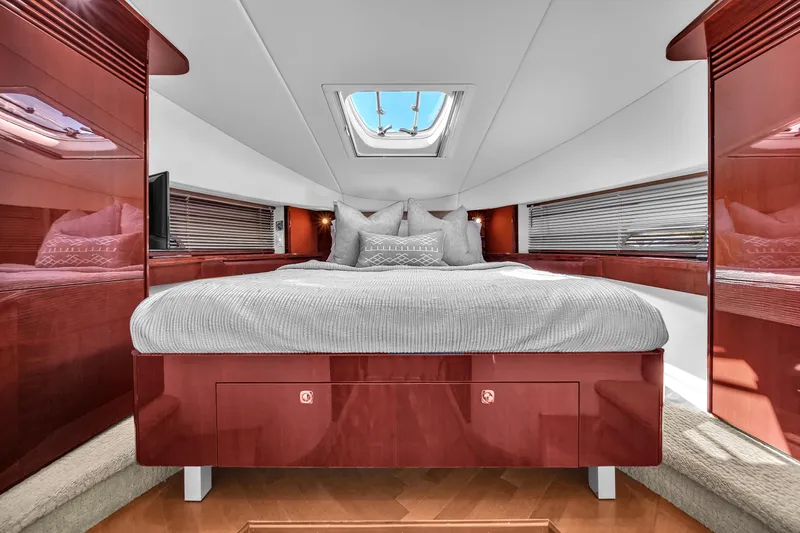  Yacht Photos Pics Luxurious cabin interior of 2010 Sea Ray 500 Sundancer yacht with skylight and plush bedding.