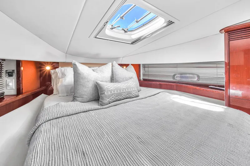  Yacht Photos Pics Luxurious cabin interior of 2010 Sea Ray 500 Sundancer yacht with skylight and plush bedding.