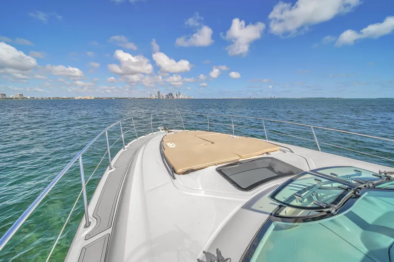  Yacht Photos Pics Sea Ray 500 Sundancer 2010 yacht cruising on open water under a clear blue sky.