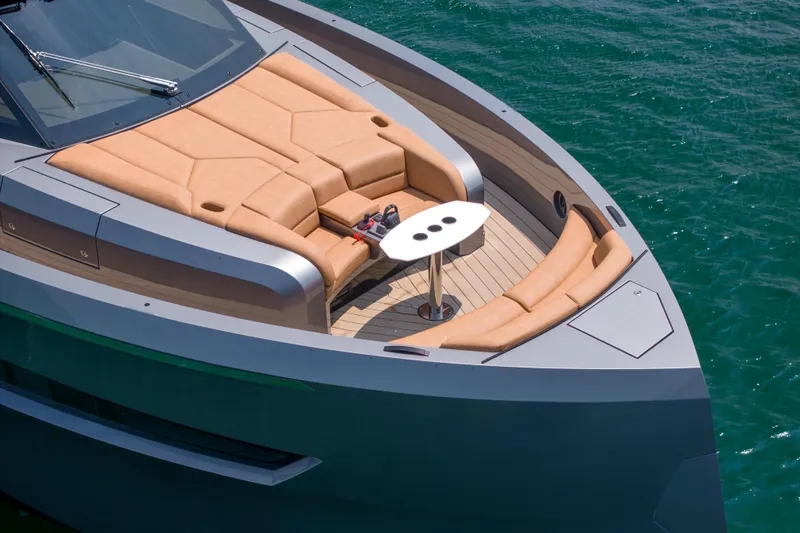 Grit Yacht Photos Pics Luxurious 2025 Steeler Bronson 67 Beachclub yacht with elegant deck seating and table.