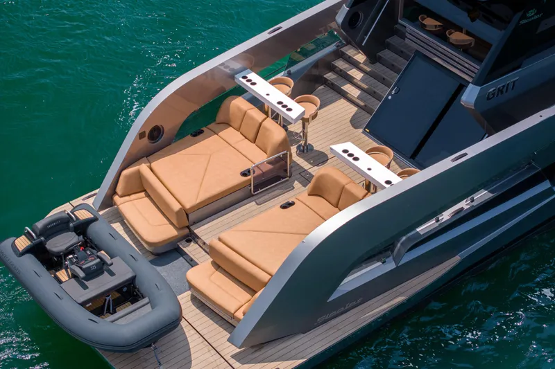 Grit Yacht Photos Pics 2025 Steeler Bronson 67 Beachclub yacht with luxurious deck seating and tender boat.