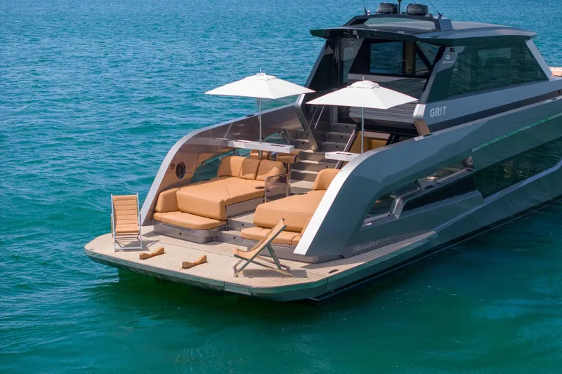 Grit Yacht Photos Pics Luxurious 2025 Steeler Bronson 67 Beachclub yacht with sun loungers and umbrellas on deck.