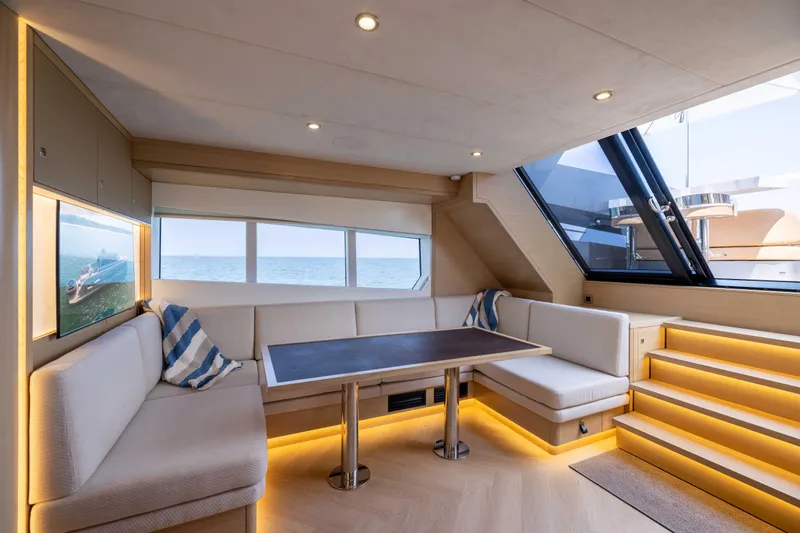 Grit Yacht Photos Pics Luxurious interior of 2025 Steeler Bronson 67 Beachclub yacht with elegant seating and ocean view.