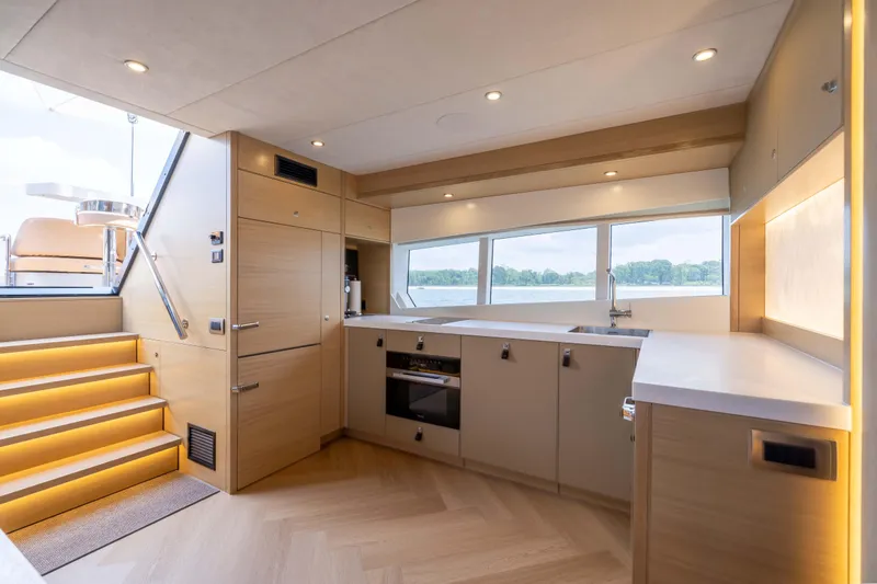Grit Yacht Photos Pics Luxurious kitchen interior of 2025 Steeler Bronson 67 Beachclub yacht with modern design.