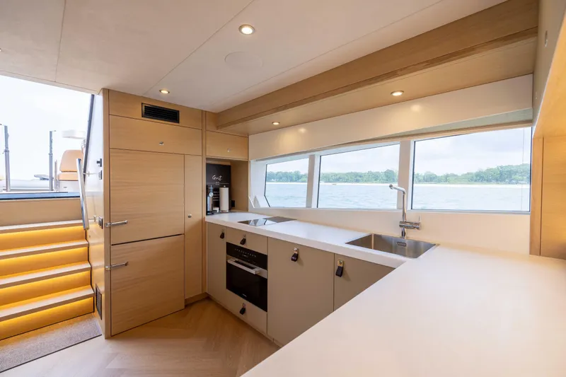 Grit Yacht Photos Pics Modern kitchen interior on 2025 Steeler Bronson 67 Beachclub yacht, featuring sleek design and lake view.