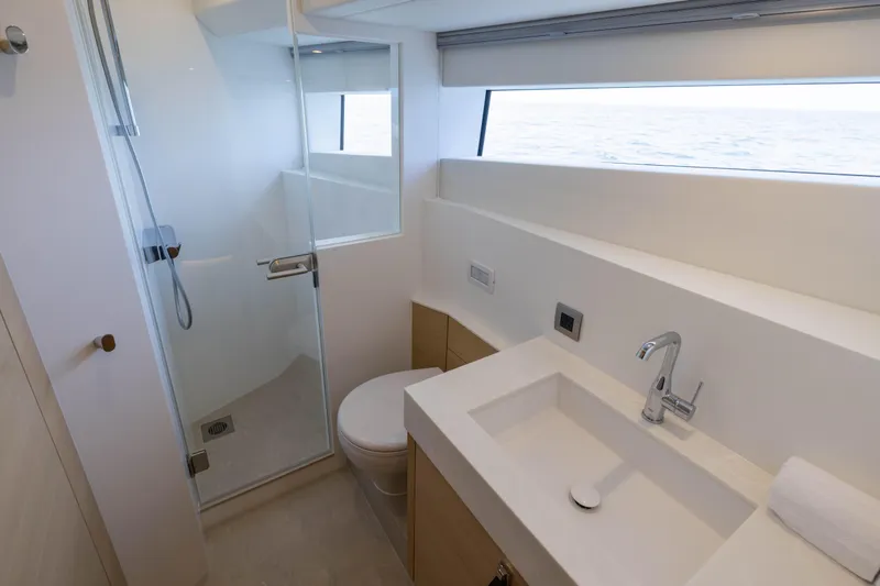 Grit Yacht Photos Pics Luxurious bathroom in 2025 Steeler Bronson 67 Beachclub yacht, featuring modern fixtures and ocean view.