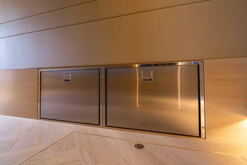 Grit Yacht Photos Pics Stainless steel storage compartments on 2025 Steeler Bronson 67 Beachclub yacht interior.