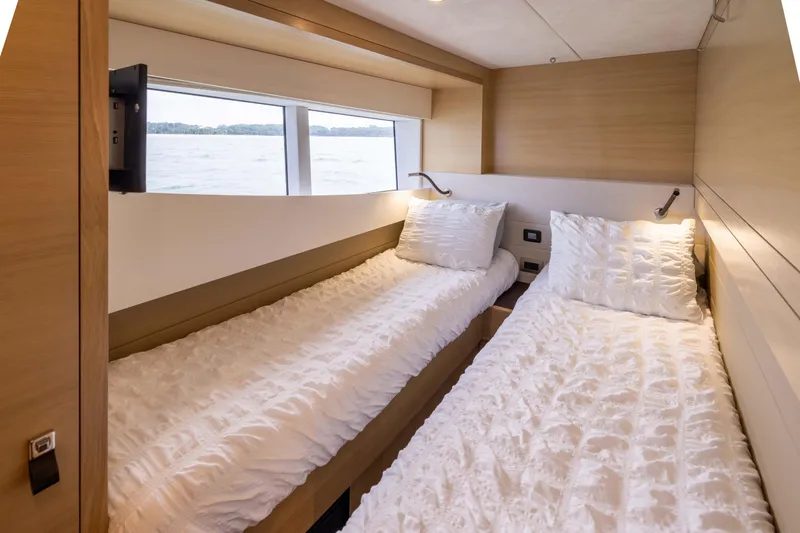 Grit Yacht Photos Pics Interior of 2025 Steeler Bronson 67 Beachclub yacht with twin beds and scenic window view.