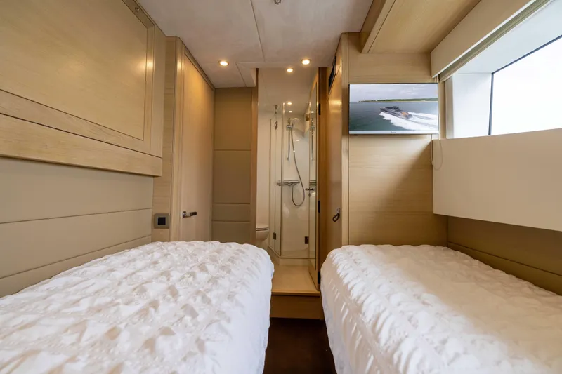 Grit Yacht Photos Pics Interior of 2025 Steeler Bronson 67 Beachclub yacht with twin beds and modern decor.