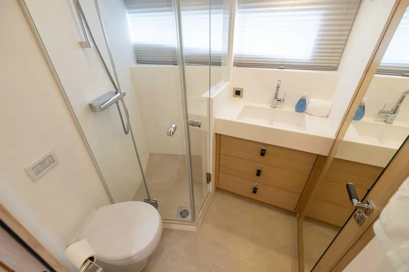 Grit Yacht Photos Pics Modern bathroom in 2025 Steeler Bronson 67 Beachclub yacht, featuring sleek design and glass shower.