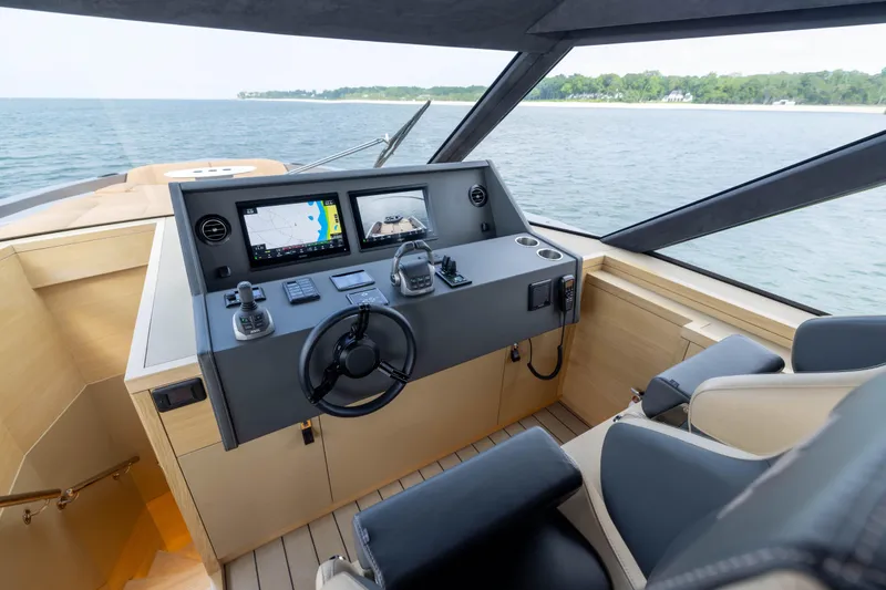 Grit Yacht Photos Pics Steeler Bronson 67 Beachclub 2025 yacht helm with modern navigation system, overlooking serene waters.