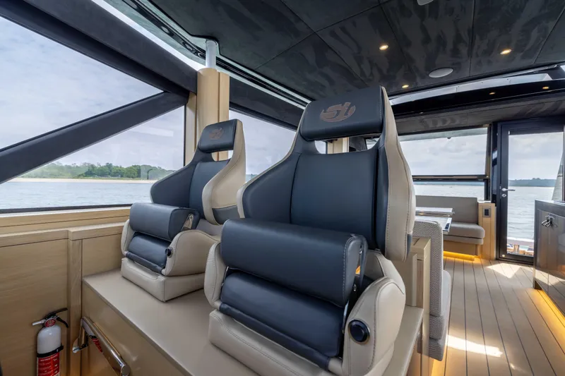 Grit Yacht Photos Pics Luxurious interior of 2025 Steeler Bronson 67 Beachclub yacht with modern seating.
